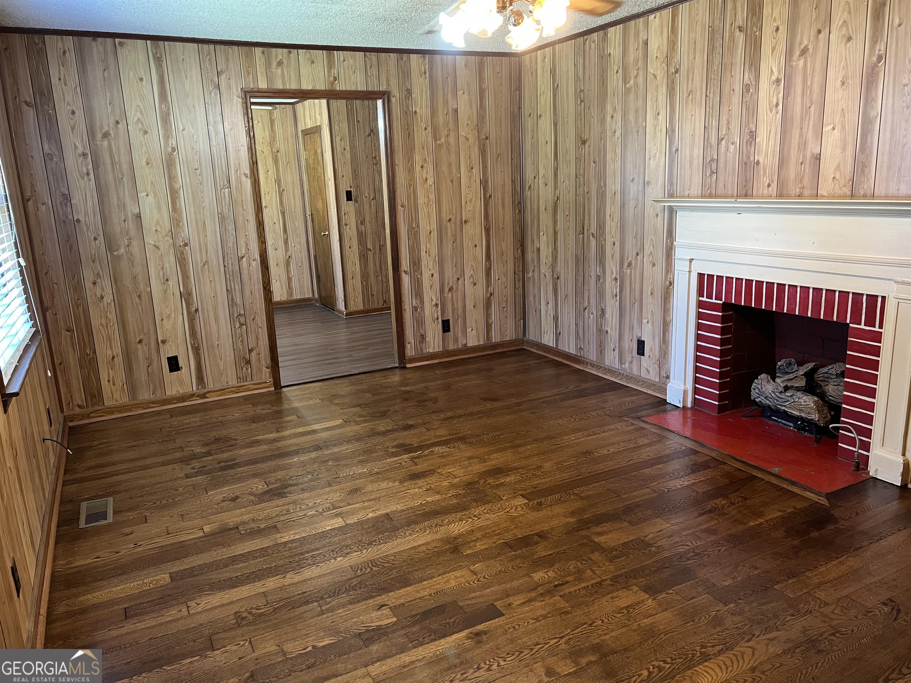 404 McArthur Boulevard Warner Robins, GA 31093 - Photo 10 of 10 a view of a livingroom with wooden floor a fireplace and a fireplace