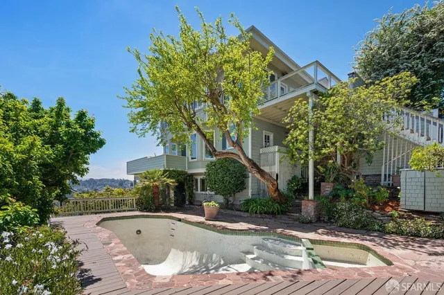 a view of an empty room with a fireplace and a window