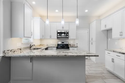a kitchen with a sink stove and refrigerator