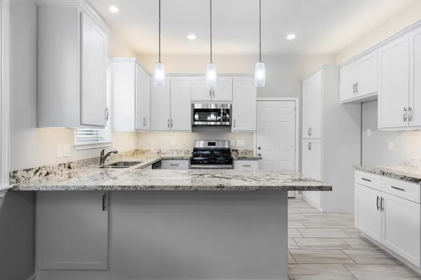 a kitchen with a sink stove and refrigerator
