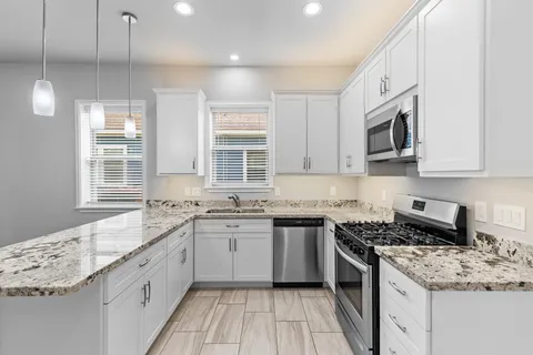 a kitchen with a sink stove and cabinets