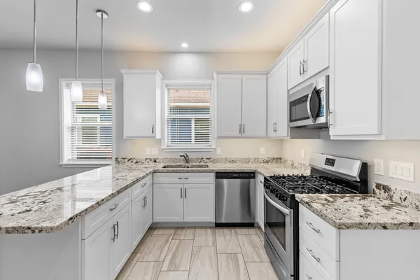 a kitchen with a sink stove and cabinets