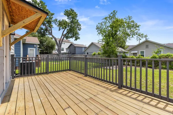a view of a house with a yard and wooden fence