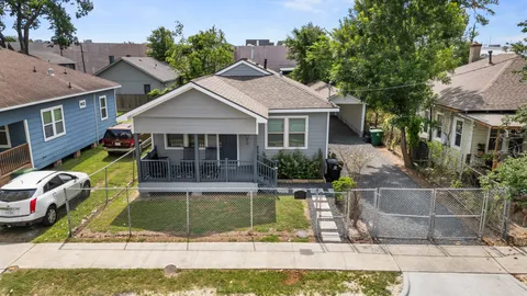 an aerial view of multiple houses with a yard