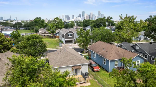 an aerial view of a house with garden space and street view