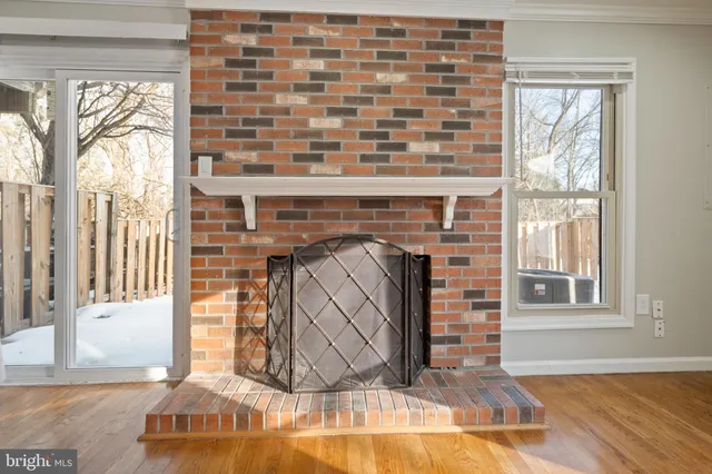 a kitchen with white cabinets and black appliances