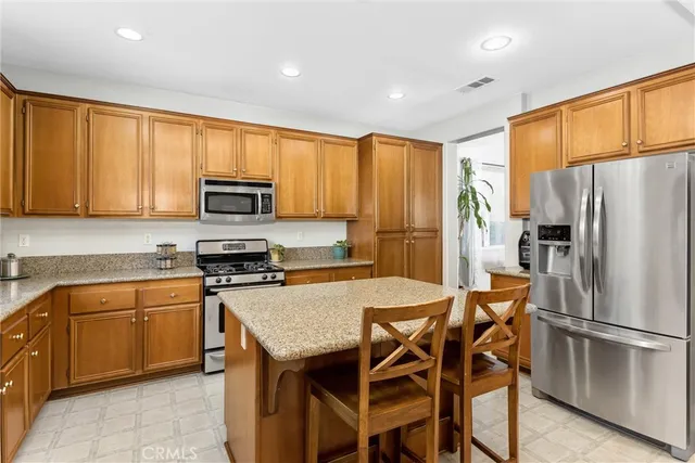 a living room with furniture kitchen view and a chandelier