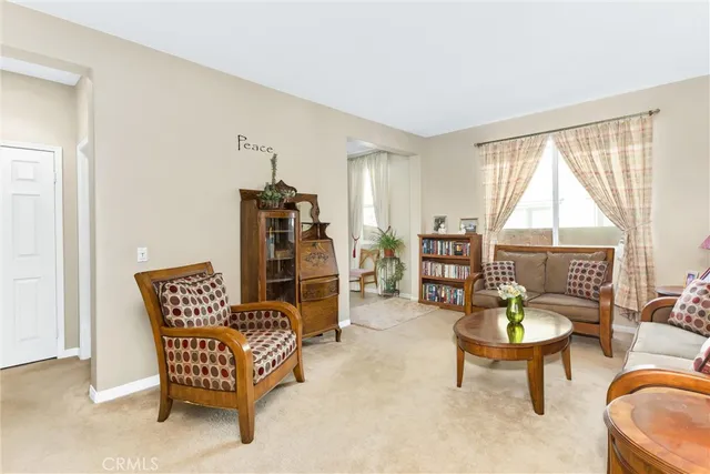 a view of a dining room with furniture a chandelier and wooden floor
