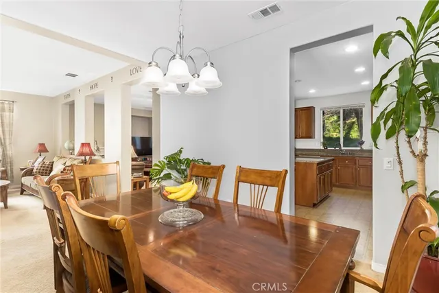 a kitchen with granite countertop stainless steel appliances a sink window and cabinets