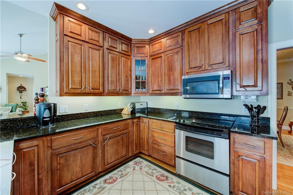 146 Pumkin Patch Road Rutherfordton, NC 28139 - Photo 18 of 48 a kitchen with stainless steel appliances granite countertop a sink stove and cabinets