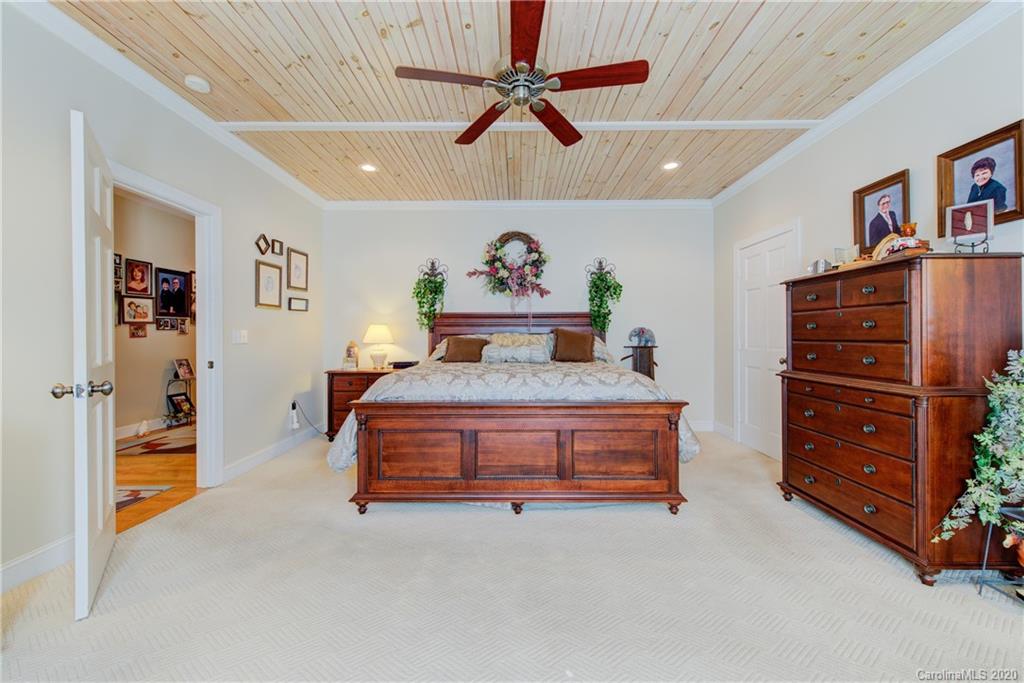 146 Pumkin Patch Road Rutherfordton, NC 28139 - Photo 24 of 48 a spacious bedroom with a bed and a ceiling fan