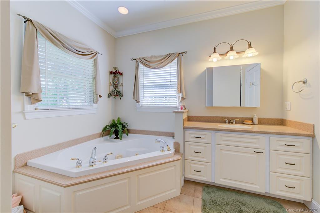 146 Pumkin Patch Road Rutherfordton, NC 28139 - Photo 28 of 48 a bathroom with a tub sink and mirror