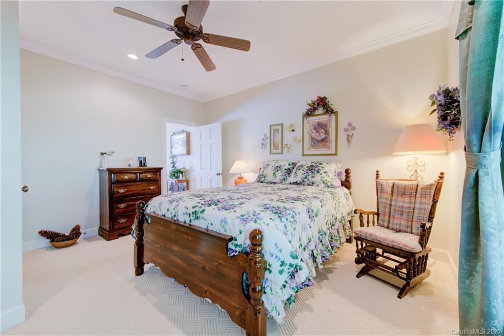 146 Pumkin Patch Road Rutherfordton, NC 28139 - Photo 31 of 48 a bedroom with a bed and a chandelier