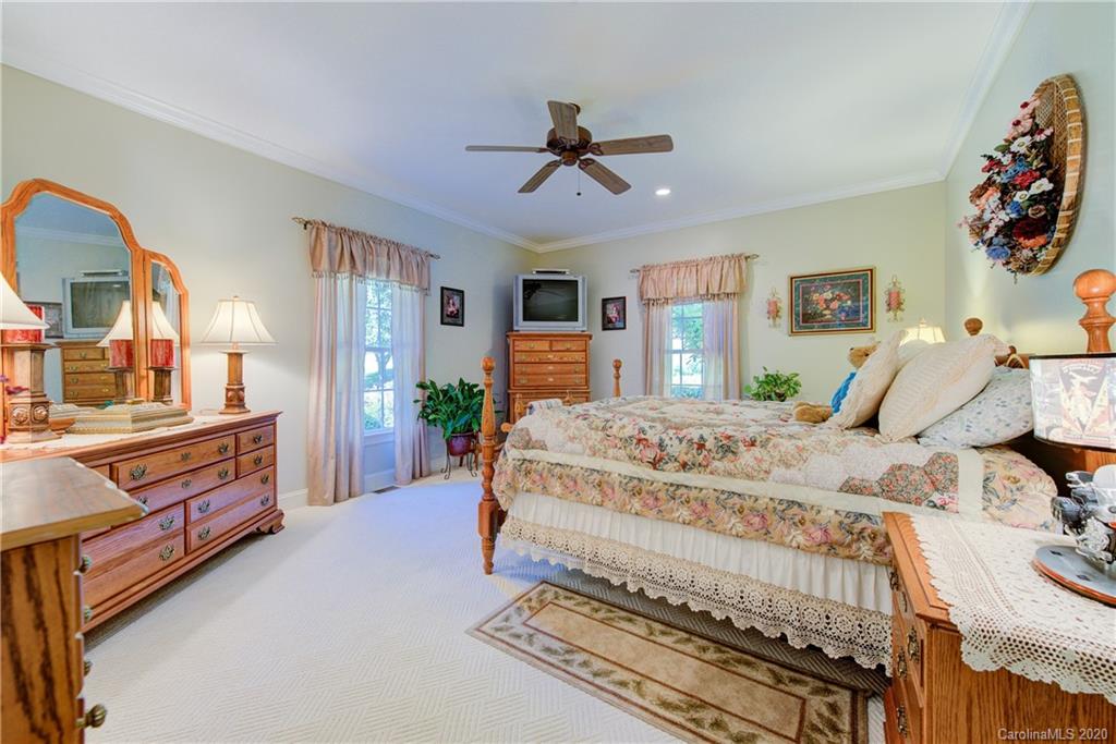 146 Pumkin Patch Road Rutherfordton, NC 28139 - Photo 33 of 48 a bedroom with a bed and a chandelier