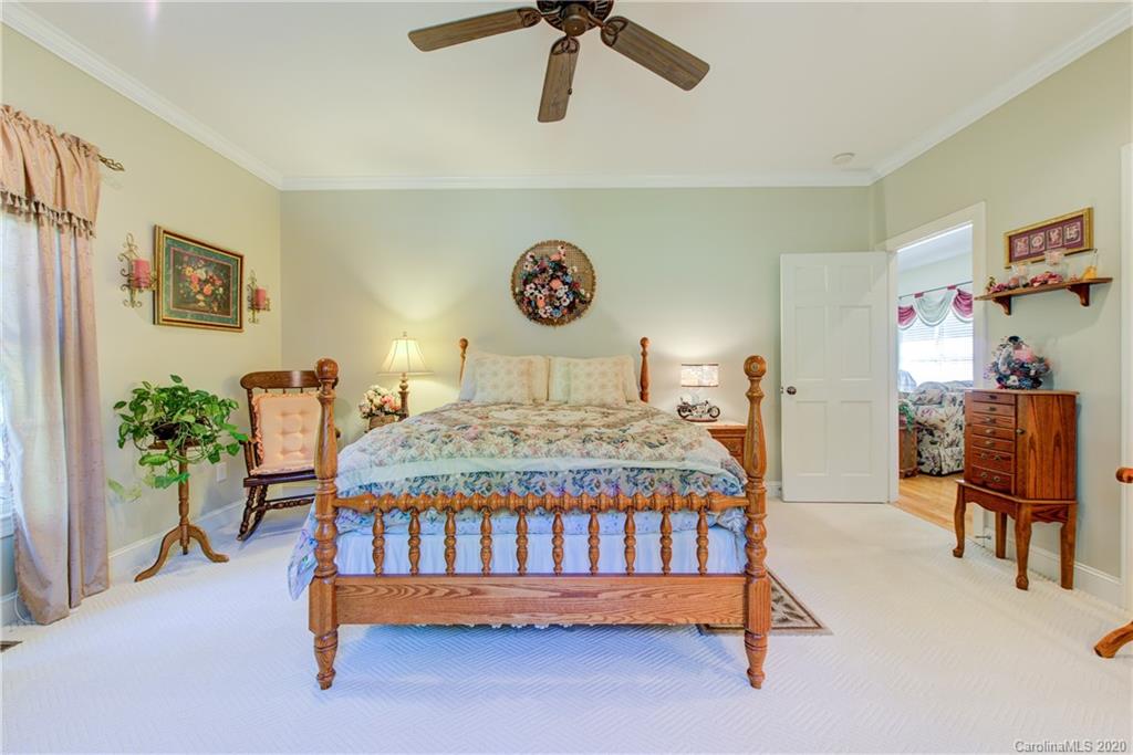 146 Pumkin Patch Road Rutherfordton, NC 28139 - Photo 34 of 48 a bedroom with a bed and a chandelier