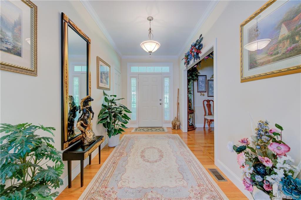 146 Pumkin Patch Road Rutherfordton, NC 28139 - Photo 9 of 48 a hallway with beautiful frames and flower vase