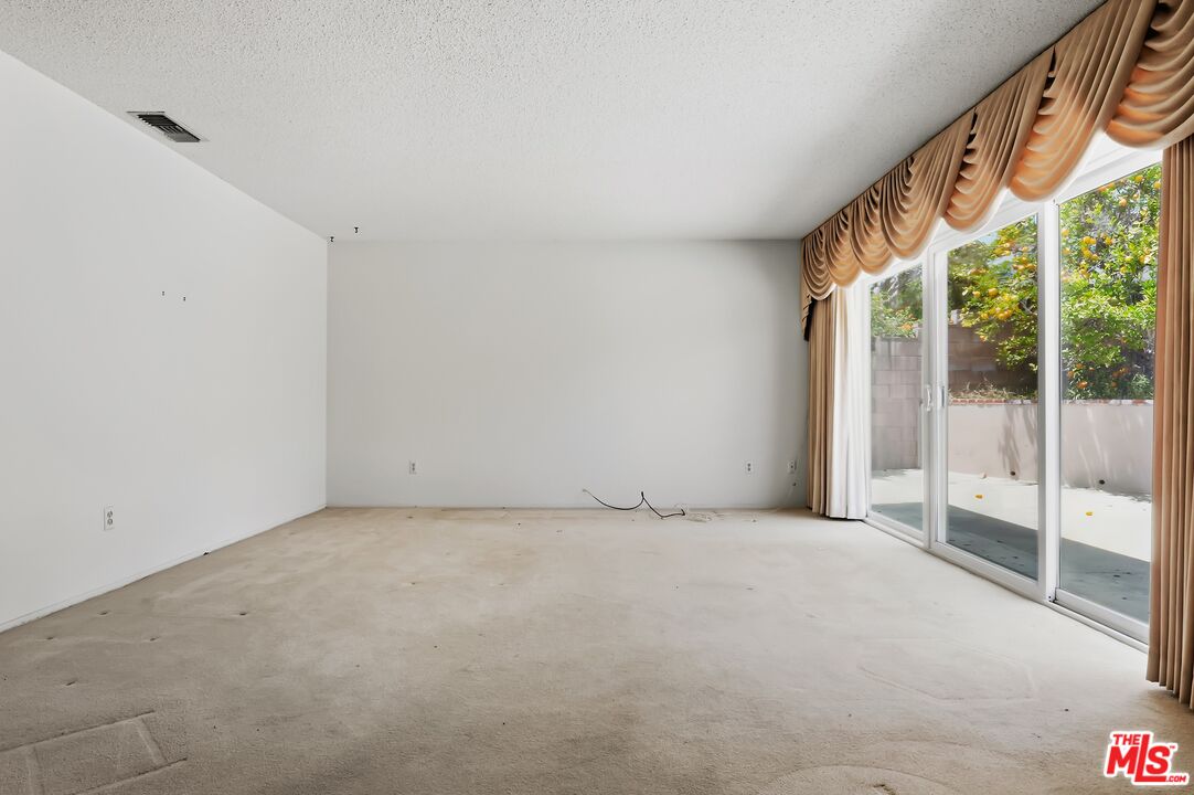 19131 Tulsa Street Porter Ranch, CA 91326 - Photo 8 of 43 a view of an empty room with windows