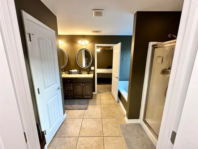 a room with wooden floor pool table and windows