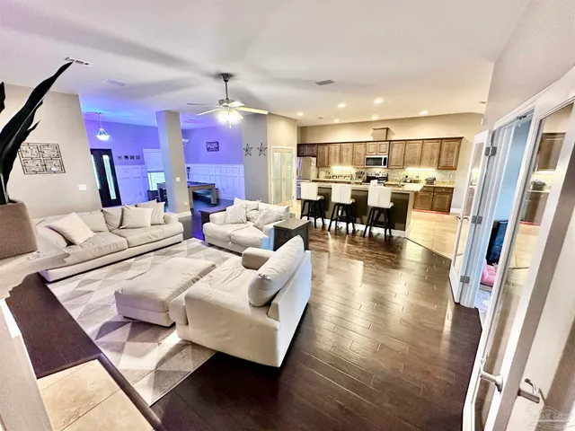 a living room with fireplace furniture and a wooden floor