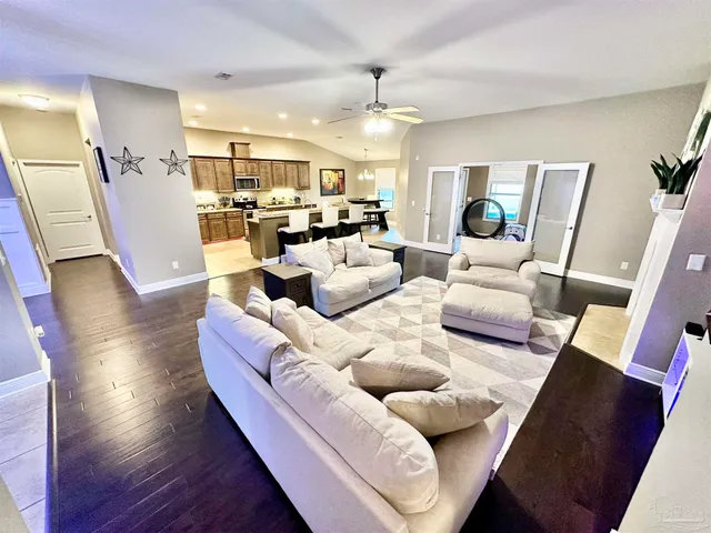 a living room with furniture and kitchen view