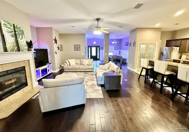 a kitchen with stainless steel appliances kitchen island granite countertop a sink dishwasher stove and refrigerator