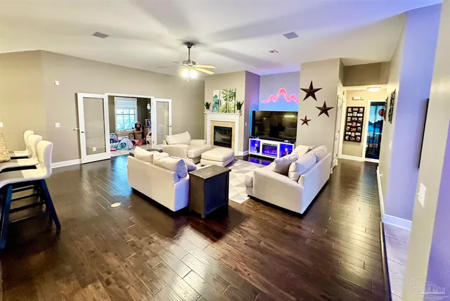 a living room with fireplace furniture and a wooden floor