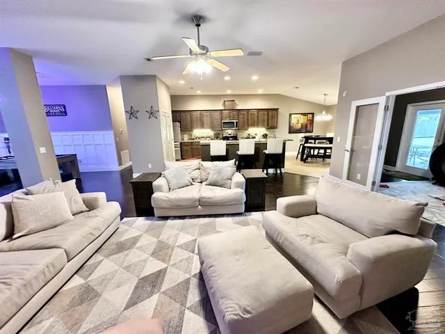 a living room with furniture a fireplace and a flat screen tv