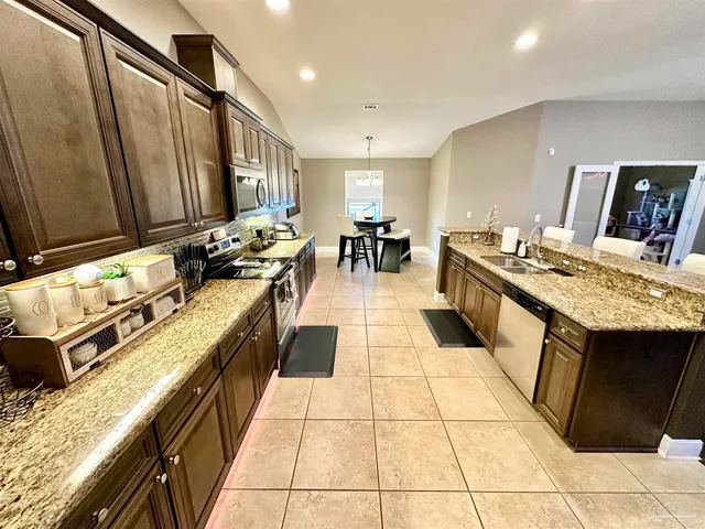 a bathroom with a sink a toilet a mirror and shower