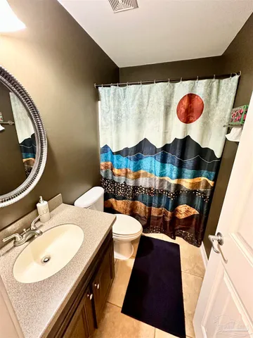 a view of a hallway and a livingroom with furniture
