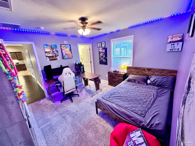 a bedroom with a bed a couch and a large window