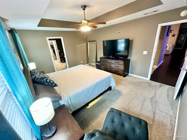 a bedroom with a bed and a couch
