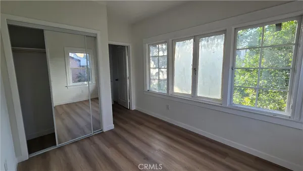 a view of hallway with stairs and wooden floor