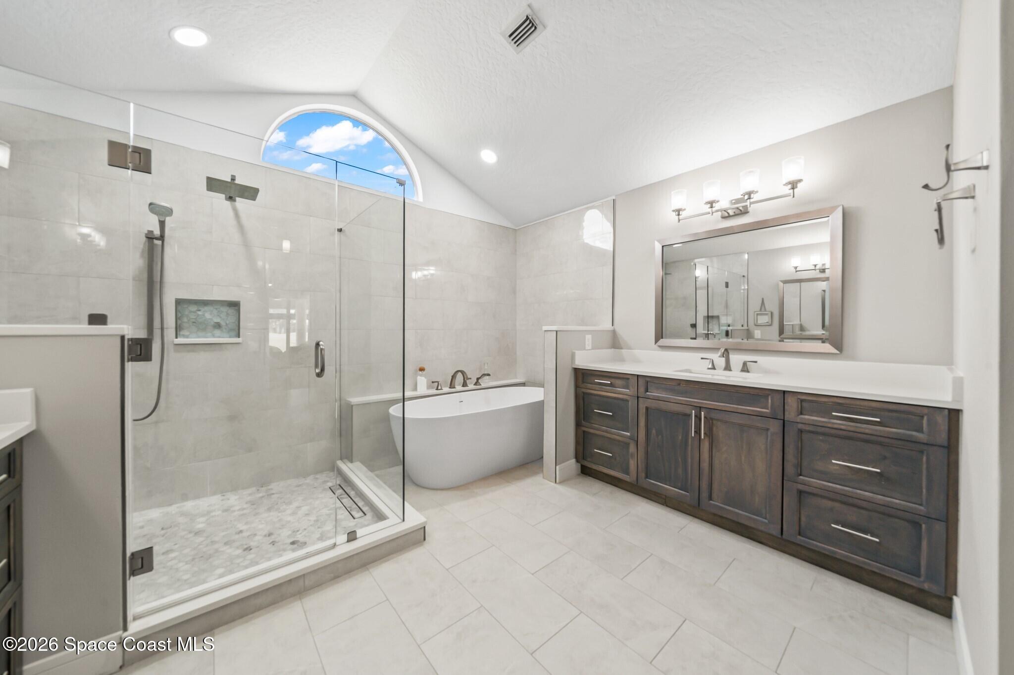 697 Spring Lake Drive Melbourne, FL 32940 - Photo 21 of 45 a bathroom with a double vanity sink mirror and shower