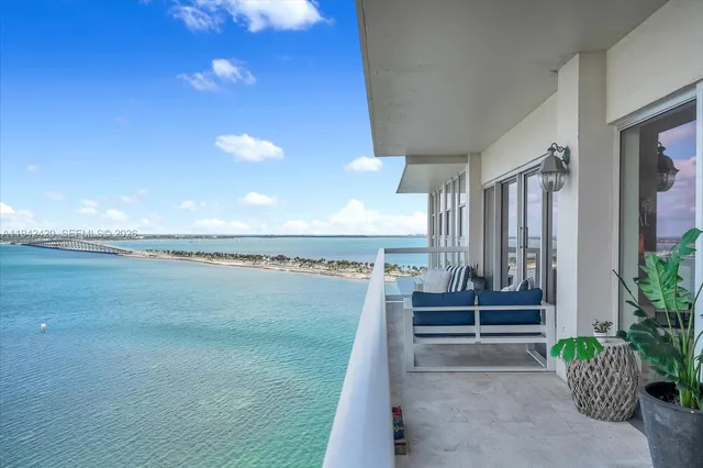 a living room with furniture a chandelier and a window