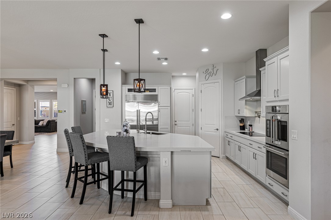 7036 Arabian Ridge Street Las Vegas, NV 89131 - Photo 21 of 64 Culinary delights await in this bright kitchen with an ample island and modern fixtures.
