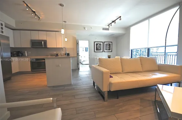 a living room with furniture and a large window