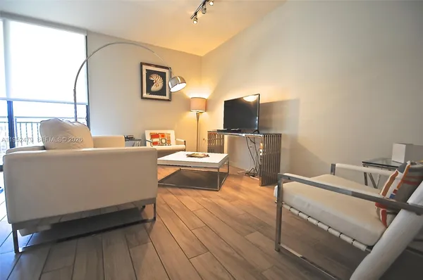 a living room with furniture and a flat screen tv