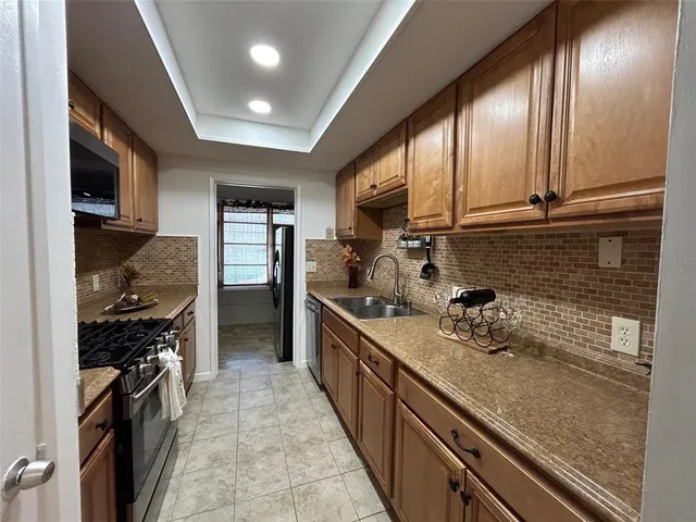 a kitchen with refrigerator and cabinets
