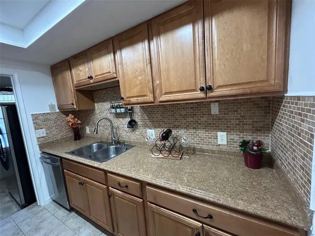 a kitchen with stainless steel appliances granite countertop a sink a stove and cabinets
