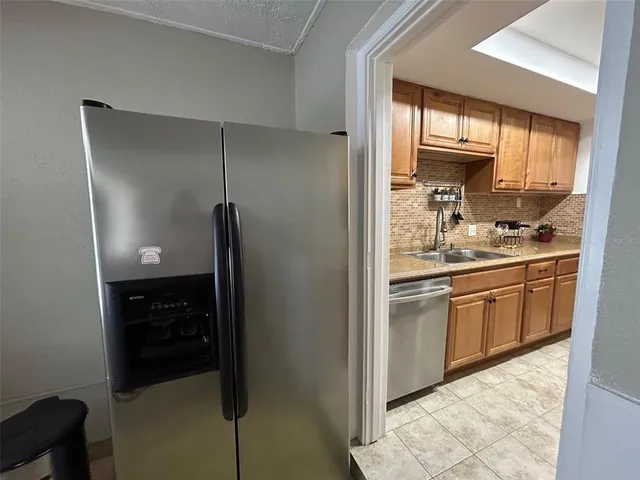 a kitchen with a sink and refrigerator