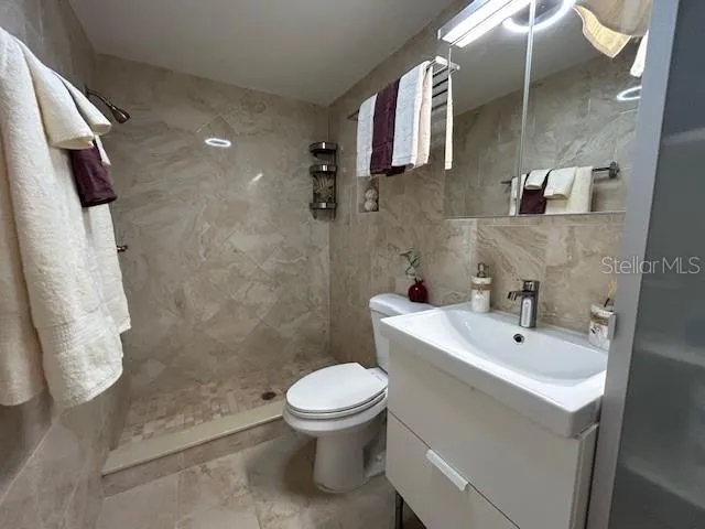 a bathroom with a toilet sink and shower