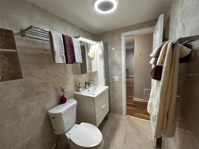 a bathroom with a sink toilet and shower