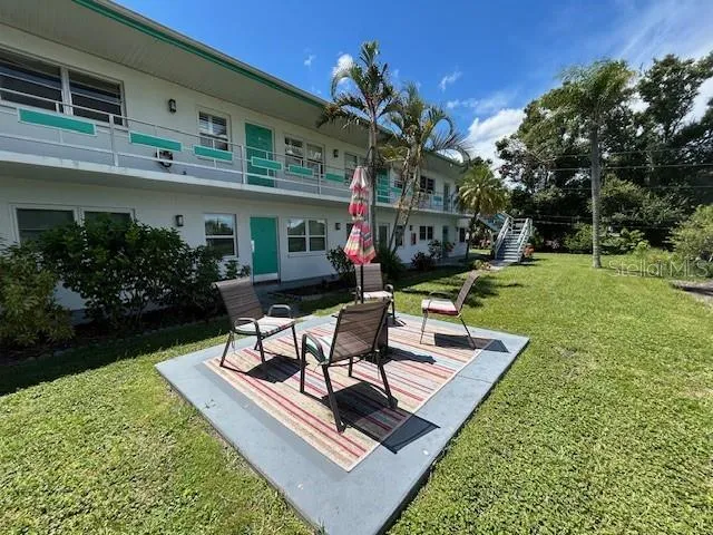 a view of a house with backyard sitting area and garden