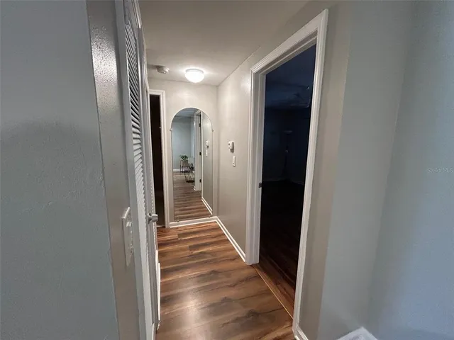 a view of a hallway with wooden floor