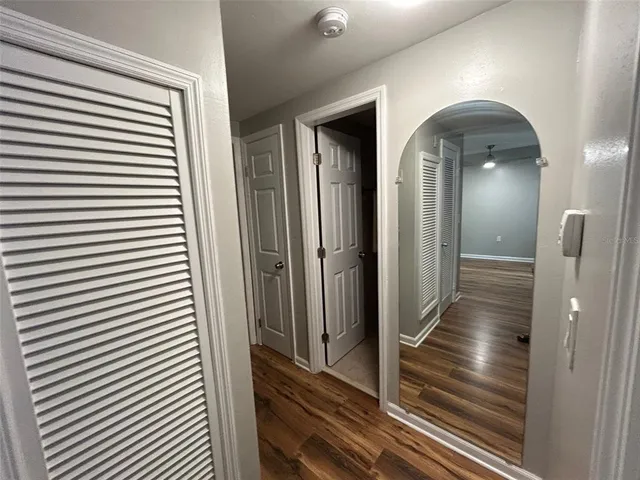 a view of a hallway with wooden floor