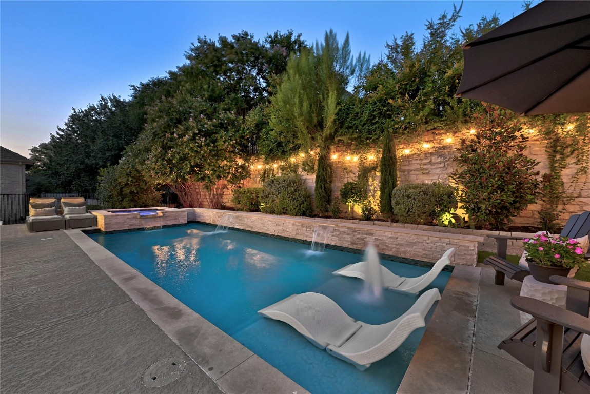 a view of swimming pool with outdoor seating and plants