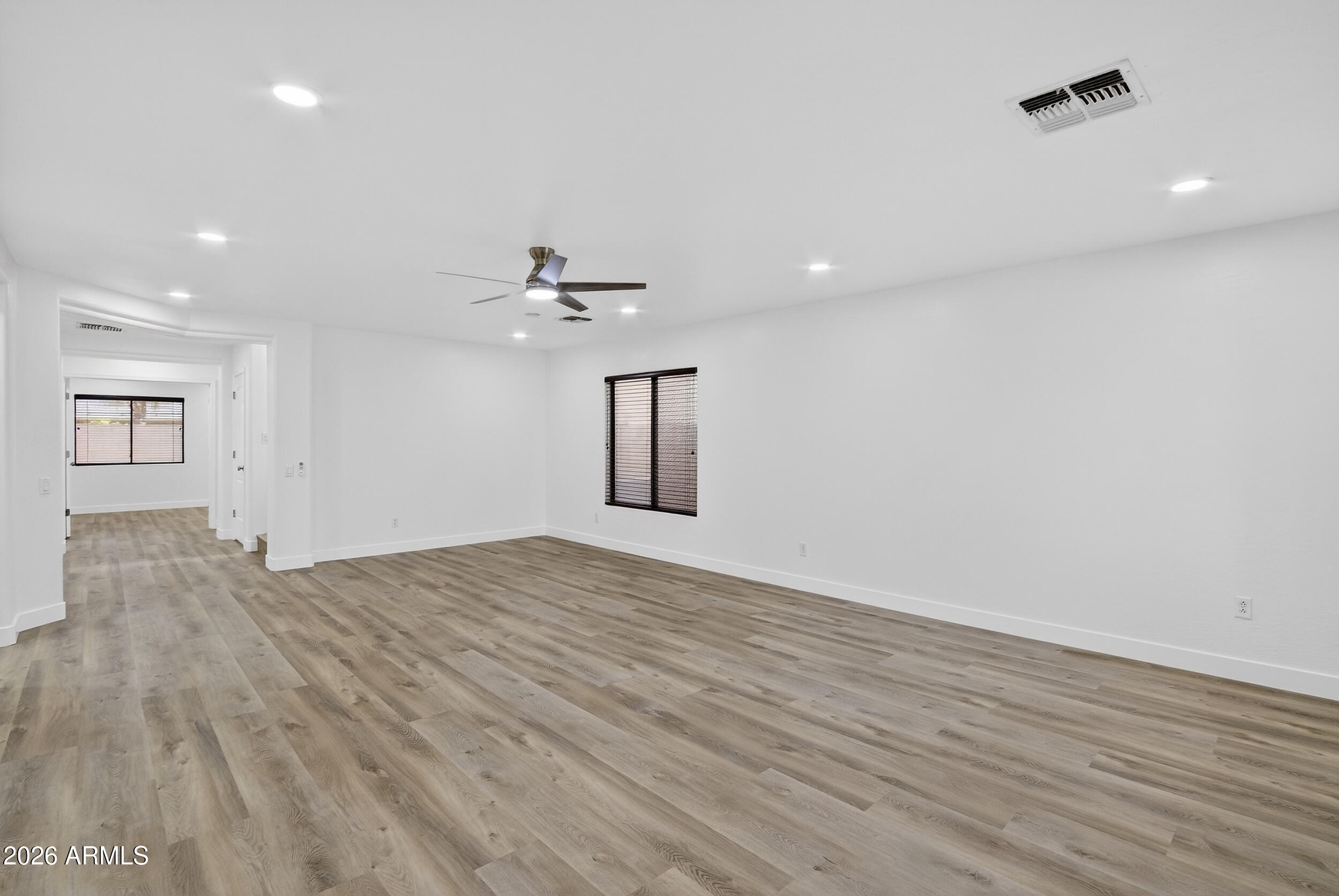 43620 West Cowpath Road Maricopa, AZ 85138 - Photo 3 of 60 a view of empty room with wooden floor