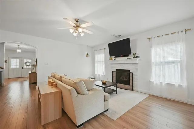a living room with furniture a fireplace and a flat screen tv