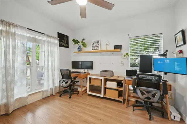 a view of a workspace with furniture and a window