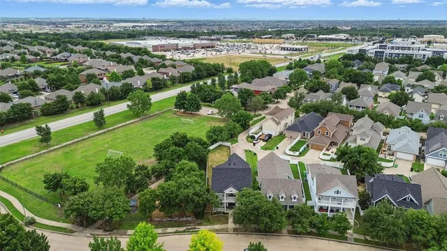 an aerial view of residential houses with outdoor space and river